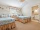 Comfortable bedroom with twin beds, nautical accents, and an adjacent bathroom for convenience at 1304 Casey Key Rd, Nokomis, FL 34275