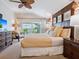 Relaxing bedroom with balcony, neutral colors, wood paneling, and soft, inviting textiles at 1304 Casey Key Rd, Nokomis, FL 34275