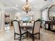 Refined dining room with a chandelier, architectural columns, and views of the beautiful outdoors at 1304 Casey Key Rd, Nokomis, FL 34275