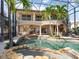 Stunning multi-story home featuring a private pool, hot tub, and outdoor kitchen at 1304 Casey Key Rd, Nokomis, FL 34275