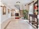 Elegant foyer with decorative tile flooring, wrought iron staircase, and sophisticated wall sconces at 1304 Casey Key Rd, Nokomis, FL 34275