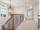 Elegant hallway features a decorative chandelier and a large window with ocean views at 1304 Casey Key Rd, Nokomis, FL 34275