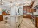 Spacious kitchen featuring an island with seating, stainless steel appliances, and custom cabinetry at 1304 Casey Key Rd, Nokomis, FL 34275