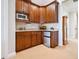 The well-appointed kitchenette features custom wood cabinetry and stainless steel mini refrigerator at 1304 Casey Key Rd, Nokomis, FL 34275