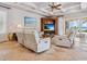 Comfortable living room features coffered ceilings, tile floors, and ocean views at 1304 Casey Key Rd, Nokomis, FL 34275
