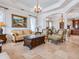 Elegant living room featuring a decorative ceiling, classic furnishings, and an open-concept design at 1304 Casey Key Rd, Nokomis, FL 34275
