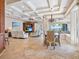 Open-concept living and dining area with tile floors, coffered ceiling, and water views at 1304 Casey Key Rd, Nokomis, FL 34275