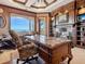 Luxurious office with ocean view features custom woodwork, fireplace, and large desk at 1304 Casey Key Rd, Nokomis, FL 34275