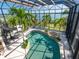 Bright sunroom with an indoor pool and tropical foliage, offering year-round enjoyment at 1304 Casey Key Rd, Nokomis, FL 34275