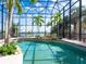 Indoor pool area with a large screened enclosure and a picturesque water view at 1304 Casey Key Rd, Nokomis, FL 34275