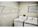 Cozy laundry room featuring modern appliances and wire shelving for storage at 14607 Brumby Ridge Ave, Lithia, FL 33547