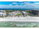 Stunning aerial view of beachfront property with pristine sands, turquoise waters, and luxury condos at 1465 Gulf Of Mexico Dr # 104, Longboat Key, FL 34228