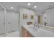 Bright bathroom with a sink, large mirror, and sliding glass shower door at 1465 Gulf Of Mexico Dr # 104, Longboat Key, FL 34228