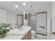 Bright bathroom featuring a sink and an enclosed glass shower at 1465 Gulf Of Mexico Dr # 104, Longboat Key, FL 34228