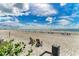 Serene beach scene with chairs and umbrellas creating a relaxing atmosphere for oceanfront enjoyment at 1465 Gulf Of Mexico Dr # 104, Longboat Key, FL 34228