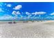 Scenic beach view featuring multiple beach chairs and umbrellas near the shoreline at 1465 Gulf Of Mexico Dr # 104, Longboat Key, FL 34228