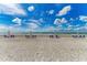 Picturesque beach with chairs and umbrellas, ideal for relaxation and enjoying the coastal scenery at 1465 Gulf Of Mexico Dr # 104, Longboat Key, FL 34228