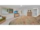 Comfortable bedroom with a queen bed, dresser with TV, and a wicker chair at 1465 Gulf Of Mexico Dr # 104, Longboat Key, FL 34228