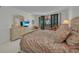 Inviting bedroom with balcony access, a king bed, and a dresser with a flat screen television at 1465 Gulf Of Mexico Dr # 104, Longboat Key, FL 34228