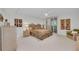 Bright bedroom featuring a queen bed, a ceiling fan, and a window with shutters at 1465 Gulf Of Mexico Dr # 104, Longboat Key, FL 34228