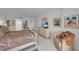 Cozy bedroom features a queen bed, dresser with TV, and a comfortable chair at 1465 Gulf Of Mexico Dr # 104, Longboat Key, FL 34228