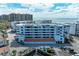 Multi-story condo building showcasing balconies, a red tile roof and well-kept grounds at 1465 Gulf Of Mexico Dr # 104, Longboat Key, FL 34228