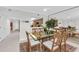 Dining area with a glass table and seating for six is adjacent to the kitchen at 1465 Gulf Of Mexico Dr # 104, Longboat Key, FL 34228