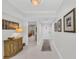 Bright hallway with neutral decor, stylish accents, and an open view into the living space at 1465 Gulf Of Mexico Dr # 104, Longboat Key, FL 34228