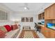 Bright home office featuring custom built-ins and a comfortable sitting area with a vibrant rug at 1465 Gulf Of Mexico Dr # 104, Longboat Key, FL 34228