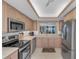 Updated kitchen features stainless steel appliances, bright cabinets and countertops at 1465 Gulf Of Mexico Dr # 104, Longboat Key, FL 34228