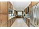 Modern kitchen featuring stainless steel appliances, granite countertops, and wood cabinets at 1465 Gulf Of Mexico Dr # 104, Longboat Key, FL 34228