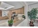 Bright kitchen featuring wood cabinetry, granite countertops, and modern appliances at 1465 Gulf Of Mexico Dr # 104, Longboat Key, FL 34228