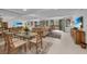 Light and bright living room with floor to ceiling mirror and outdoor views at 1465 Gulf Of Mexico Dr # 104, Longboat Key, FL 34228