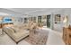 Large living room features cozy seating, large tv, access to the balcony and lots of space at 1465 Gulf Of Mexico Dr # 104, Longboat Key, FL 34228