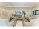 Well lit lounge area showcasing cozy seating arrangement and coastal decor at 1465 Gulf Of Mexico Dr # 104, Longboat Key, FL 34228