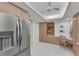 Office space with refrigerator access featuring built-in desk, cabinets, and shelving at 1465 Gulf Of Mexico Dr # 104, Longboat Key, FL 34228