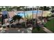 Community pool with sun loungers, palm trees and manicured landscaping at 1465 Gulf Of Mexico Dr # 104, Longboat Key, FL 34228