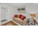 Cozy sitting area with comfortable sofa, decorative pillows, and a stylish rug, creating a welcoming space at 1465 Gulf Of Mexico Dr # 104, Longboat Key, FL 34228