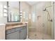 Modern bathroom featuring a glass-enclosed shower, granite countertop and vanity at 1805 7Th St E, Palmetto, FL 34221