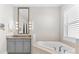 Bright bathroom with a soaking tub, granite countertop and vanity with ample lighting at 1805 7Th St E, Palmetto, FL 34221