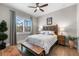 Cozy bedroom with a carved wood headboard, wood floors, and a bright window at 1805 7Th St E, Palmetto, FL 34221