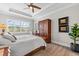 Bedroom with wood floors, tray ceiling, wardrobe, and natural light from the window at 1805 7Th St E, Palmetto, FL 34221
