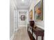 An elegant hallway featuring beautiful artwork, a console table, and stylish flooring at 1805 7Th St E, Palmetto, FL 34221