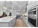 Contemporary kitchen with gray cabinets, stainless steel appliances, a large island, and hardwood floors at 1805 7Th St E, Palmetto, FL 34221