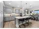 Modern kitchen featuring gray cabinets, quartz countertops, stainless steel appliances, and an island with pendant lighting at 1805 7Th St E, Palmetto, FL 34221