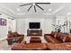Inviting living room featuring leather seating, a fireplace, and modern accents at 1805 7Th St E, Palmetto, FL 34221