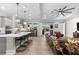 Open floor plan featuring a kitchen island, dining area, and a spacious living room with hardwood floors at 1805 7Th St E, Palmetto, FL 34221