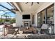 An inviting screened-in patio with a stone fireplace and comfortable seating for outdoor enjoyment at 1805 7Th St E, Palmetto, FL 34221