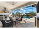Relaxing outdoor patio includes a full kitchen, comfortable seating, and views of the pool area at 1805 7Th St E, Palmetto, FL 34221