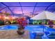 Inviting pool area features lounge seating, lush landscaping, and clear blue water at sunset at 1805 7Th St E, Palmetto, FL 34221